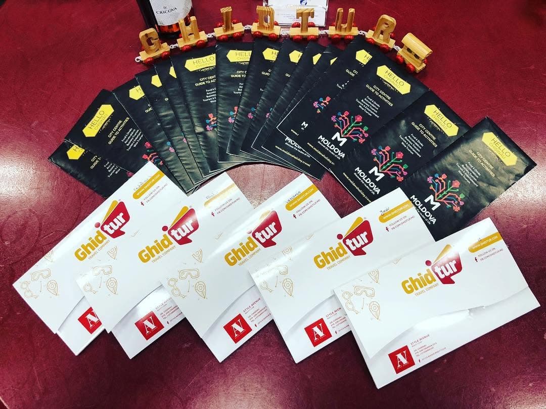 The burgundy and gold logo on envelopes alongside Moldova guidebooks.