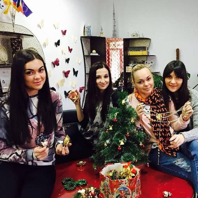 Holiday preparations at the office: the team decorating a Christmas tree.
