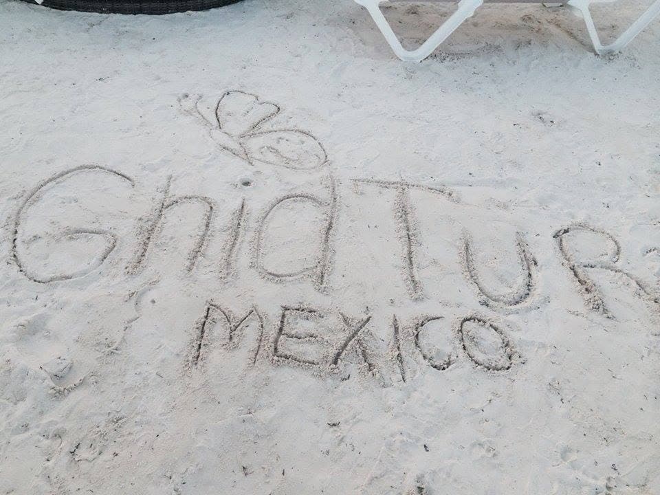“GhidTur Mexico” and a butterfly drawn in the sand.
