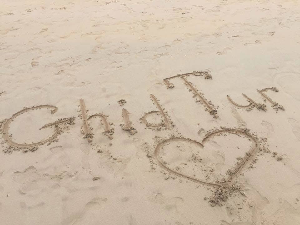 GhidTur with love — a close-up of a message in the sand.